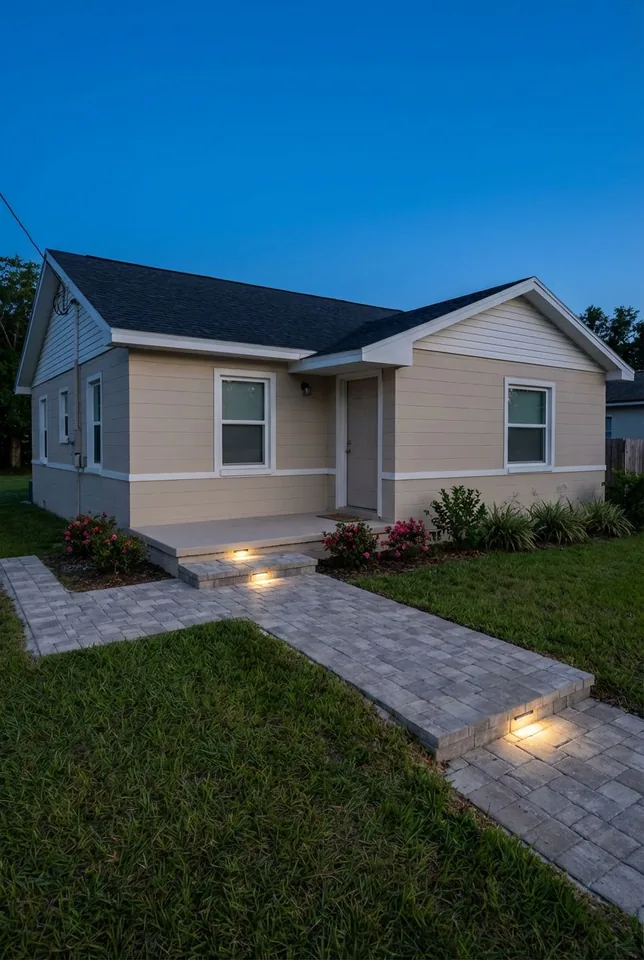 Concept rendering of a gray paver walkway and entry step with recessed lights at dusk